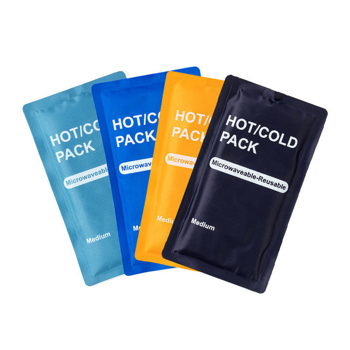 Four reusable hot and cold gel packs with fabric sleeves in a storage tray